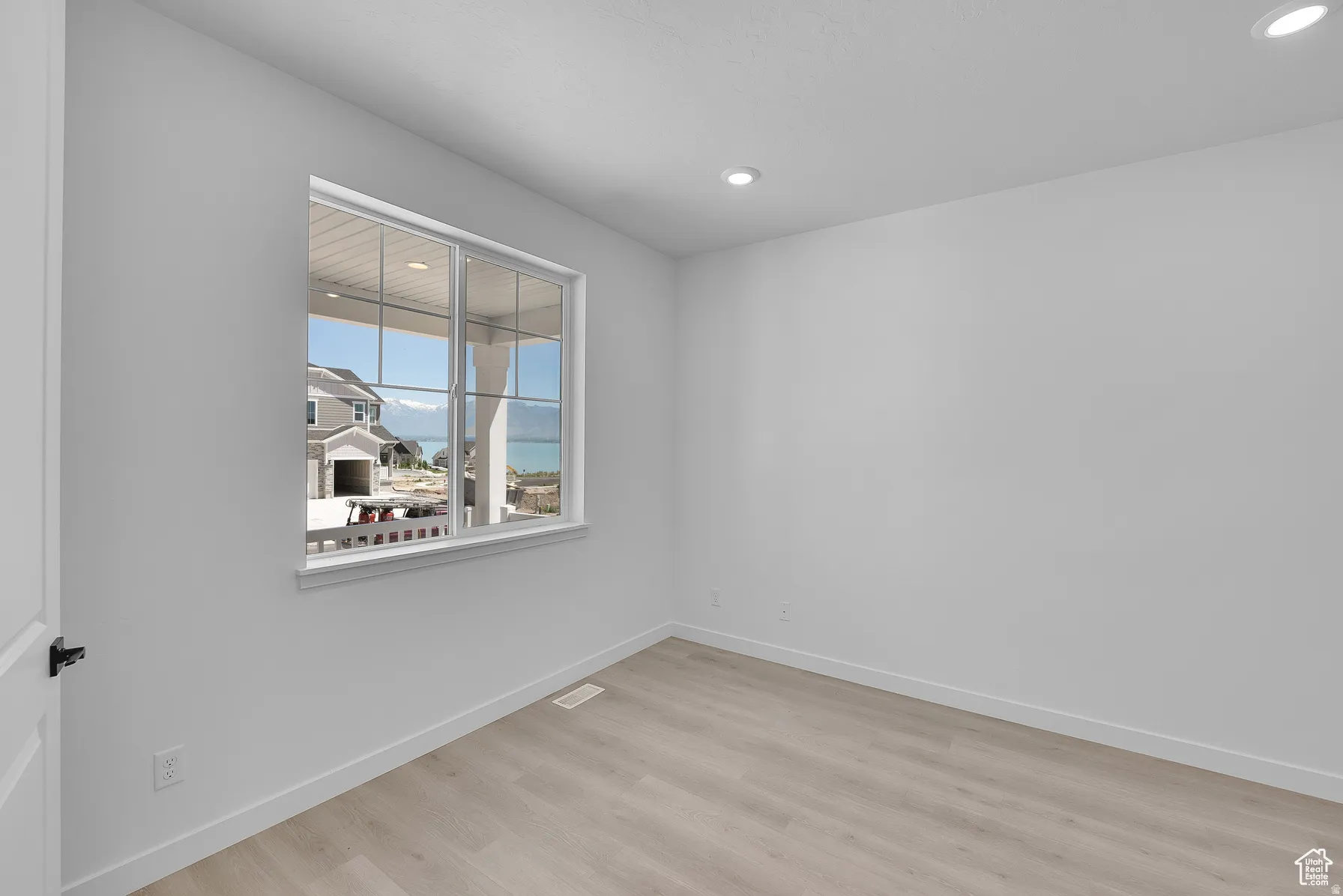 *Colors may vary** Empty room featuring light wood finished floors and recessed lighting