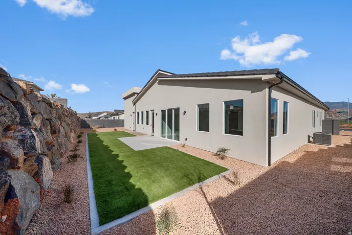 Back of property with a patio area, stucco siding, and a fenced backyard