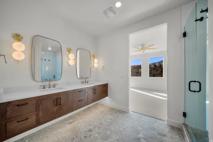 Bathroom featuring double vanity, a shower stall, and a bath