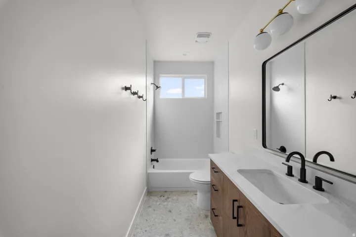 Bathroom featuring vanity and shower / bath combination
