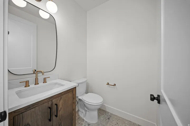 Half bathroom featuring vanity and baseboards