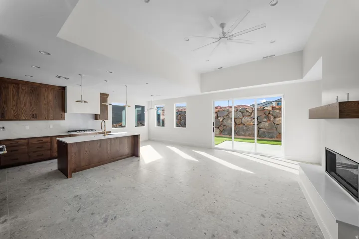 Kitchen featuring open floor plan, a center island with sink, modern cabinets, and healthy amount of natural light
