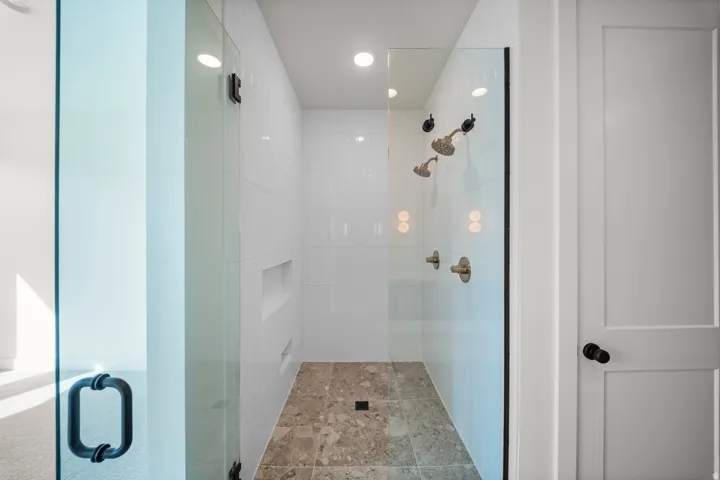 Bathroom with a shower stall and recessed lighting