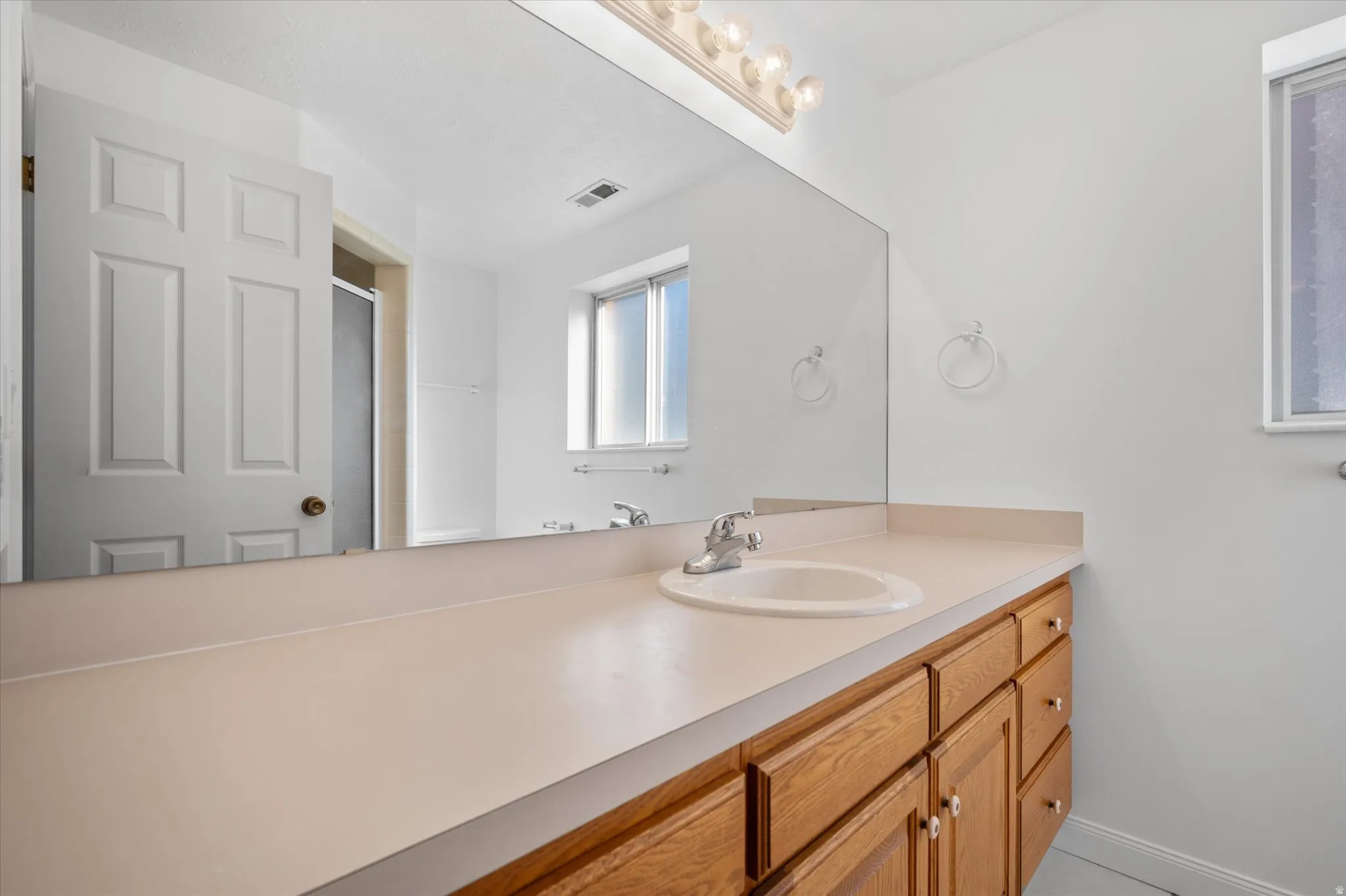 Bathroom with vanity and a stall shower