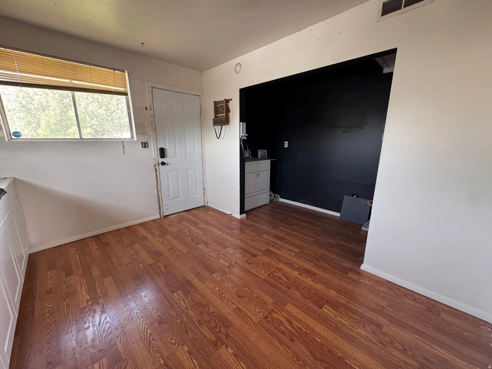 Warm wood-finish flooring extending throughout the space