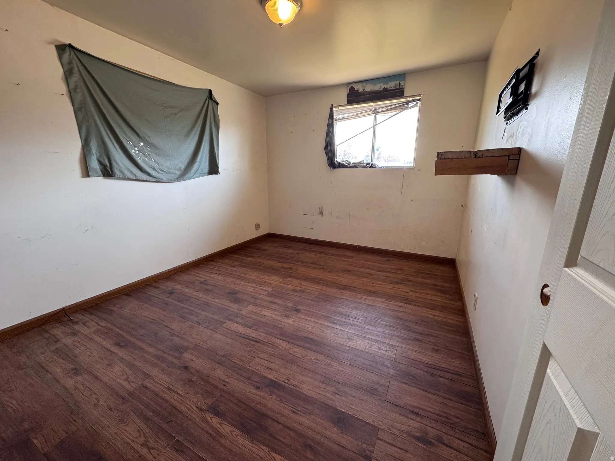 Room featuring wood-finish flooring and light-toned walls
