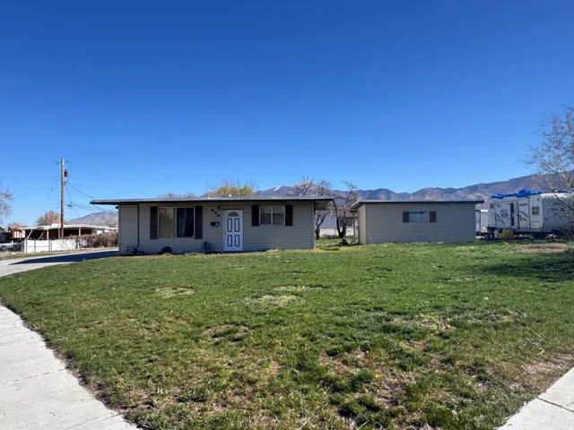 Single story home with a mountain view and a front yard