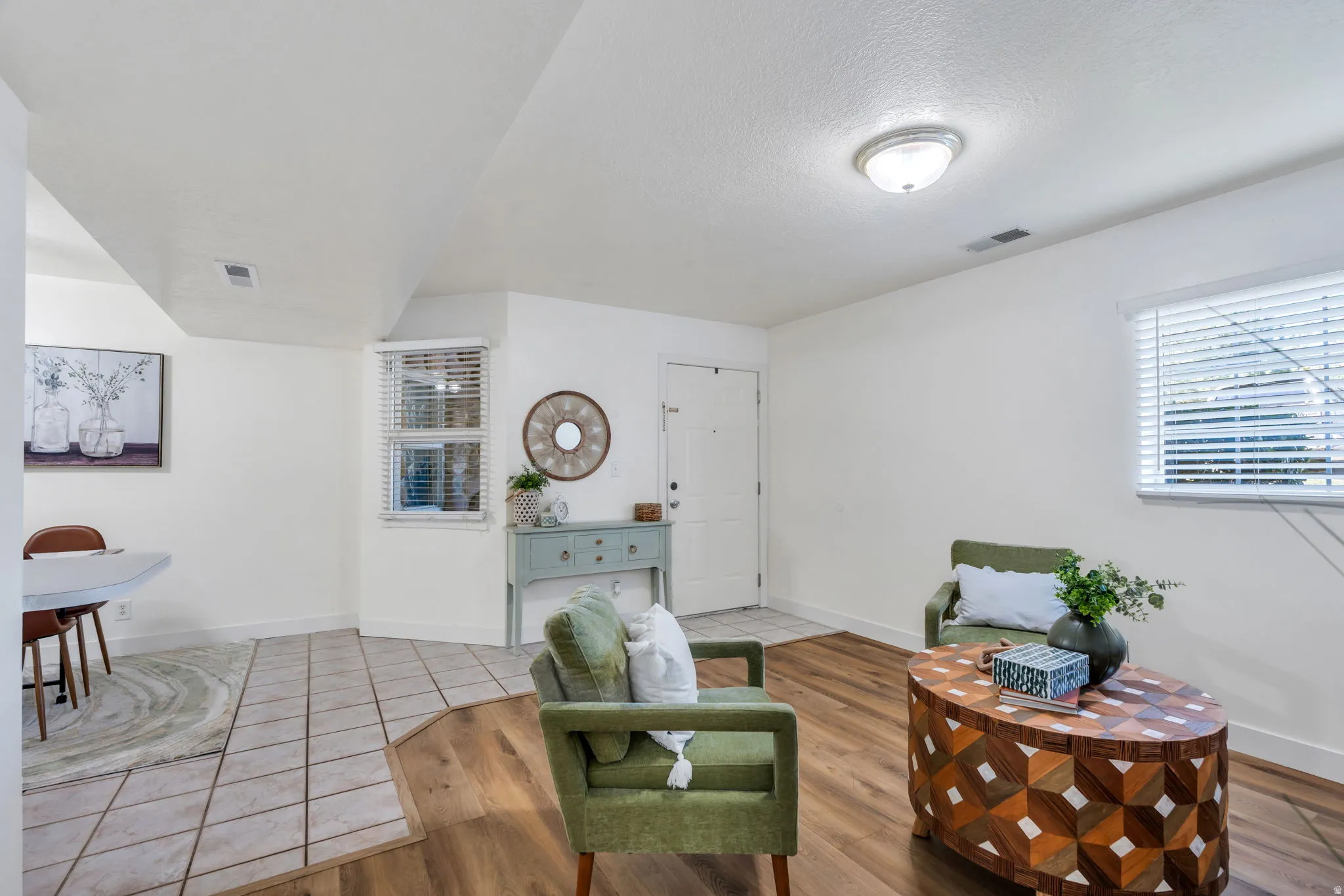 Sitting room featuring light tile patterned flooring and a textured ceiling