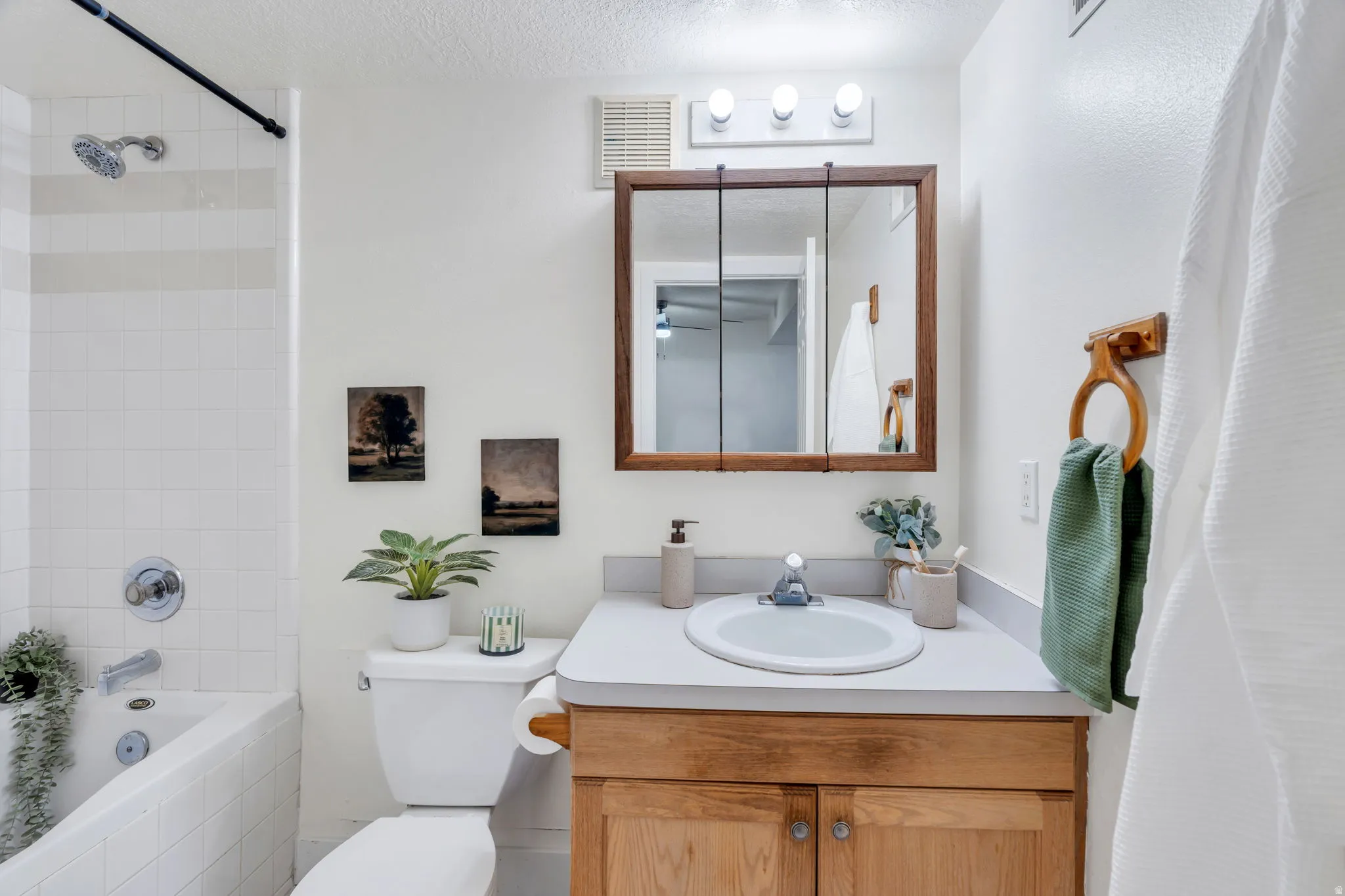 Bathroom featuring vanity and tub / shower combination