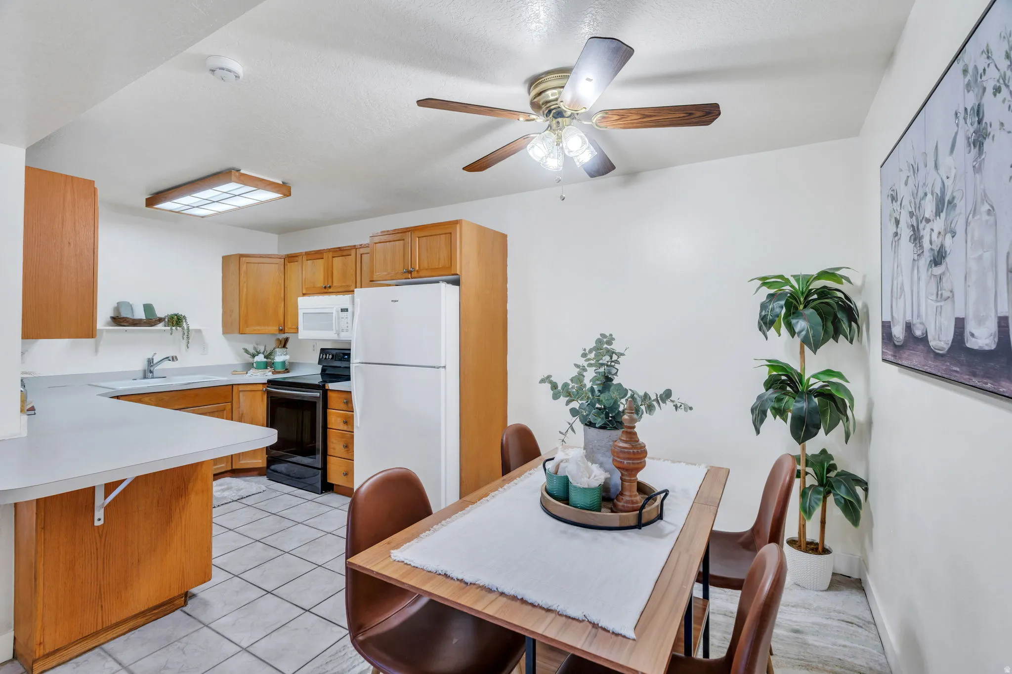Dining room featuring ceiling fan and light tile patterned flooring
