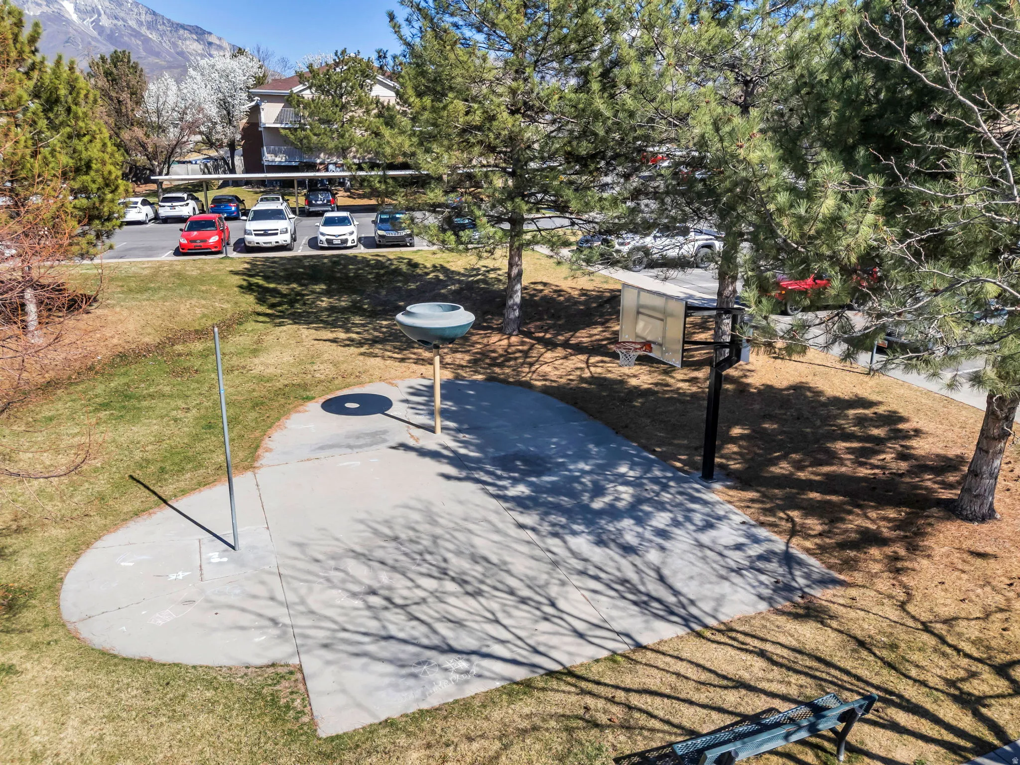 View of sport court with a yard and a mountain view
