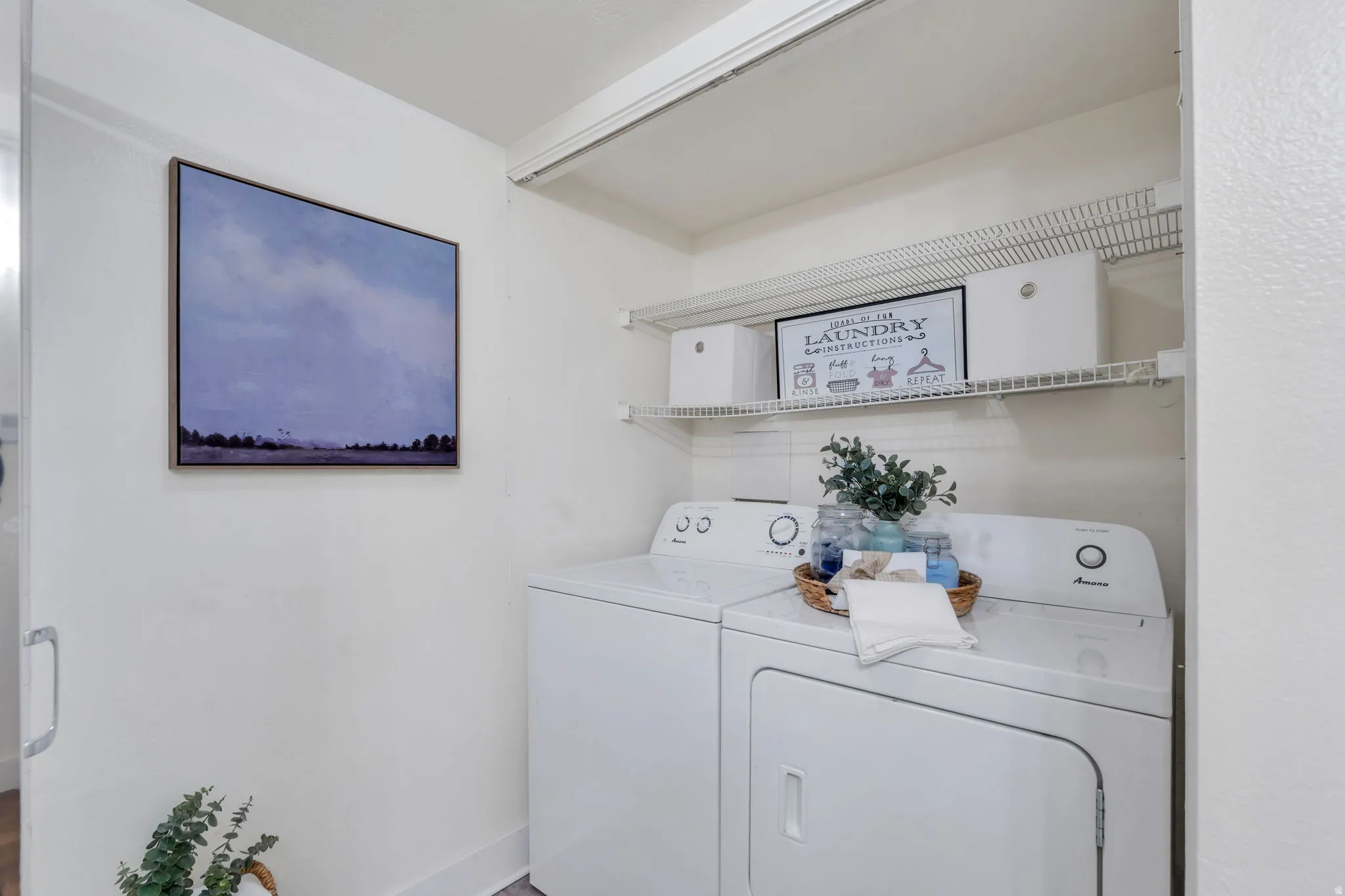 Laundry area featuring independent washer and dryer and baseboards