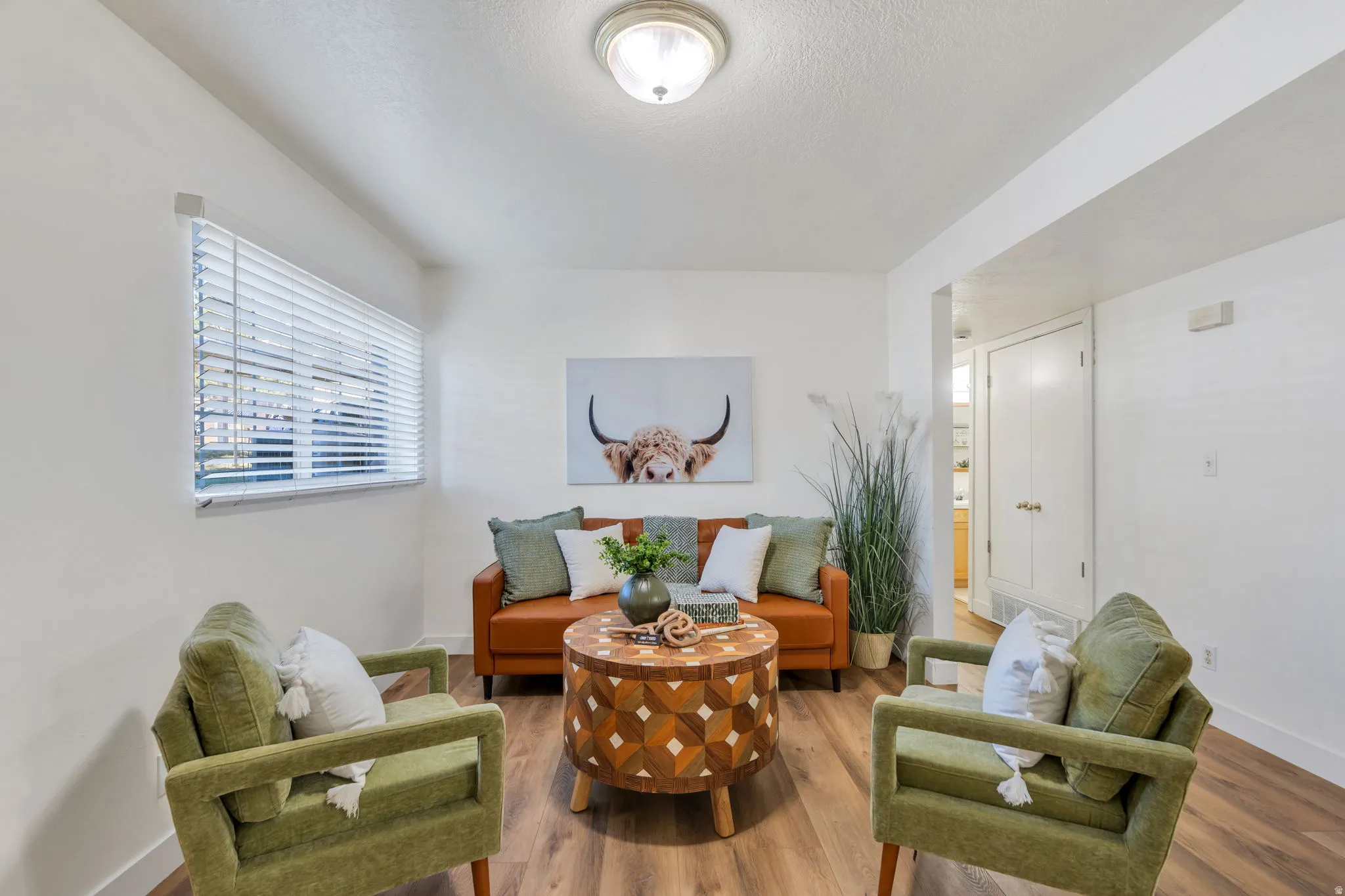 Living area featuring wood finished floors and a textured ceiling