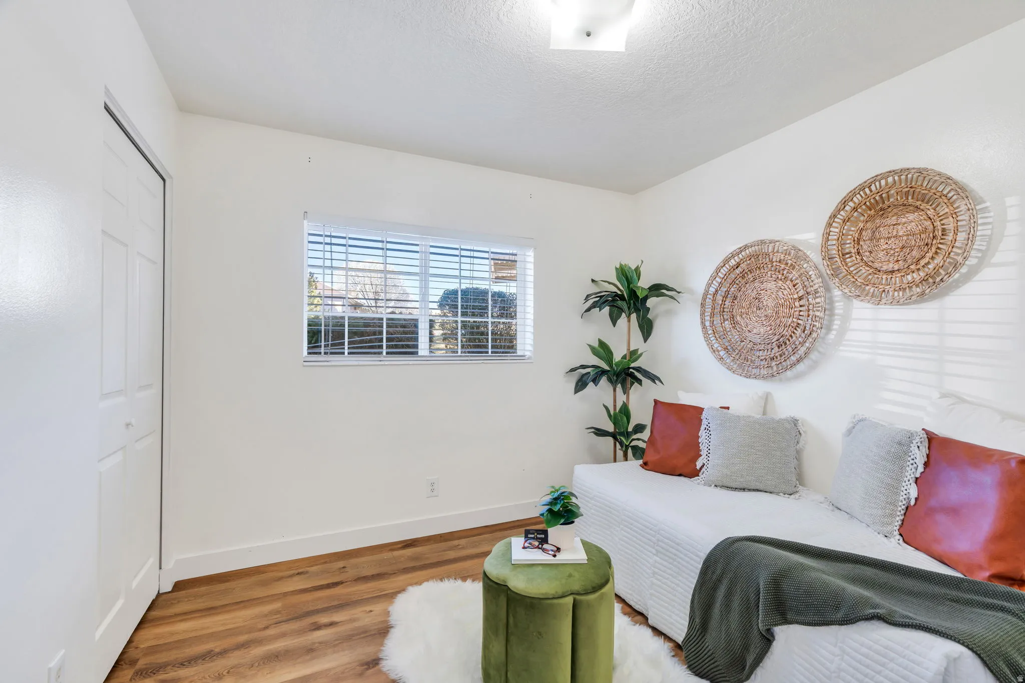 Sitting room with baseboards and wood finished floors