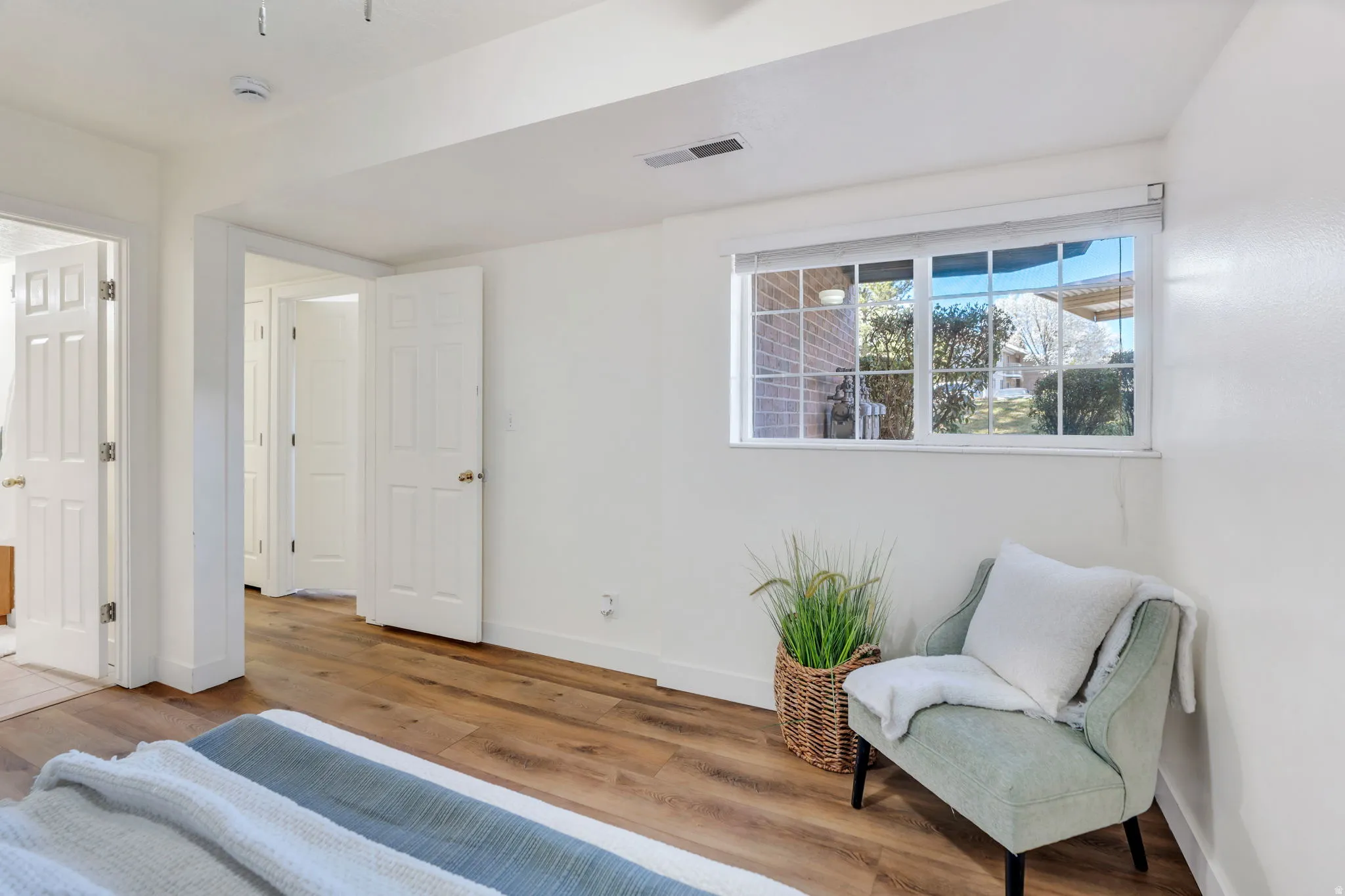 Bedroom with wood finished floors and baseboards