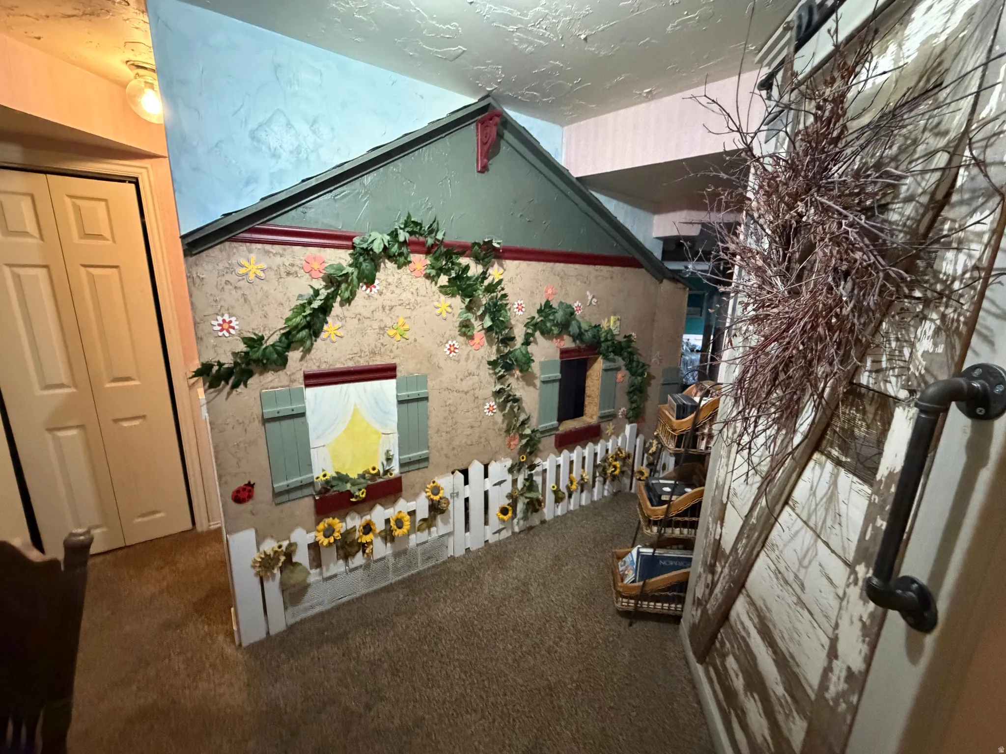 Detailed view of carpet flooring and a textured ceiling