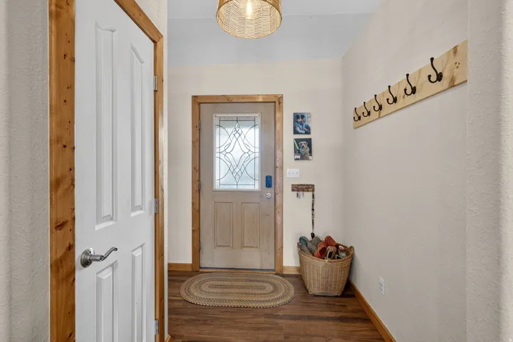 Doorway to outside featuring baseboards and wood finished floors
