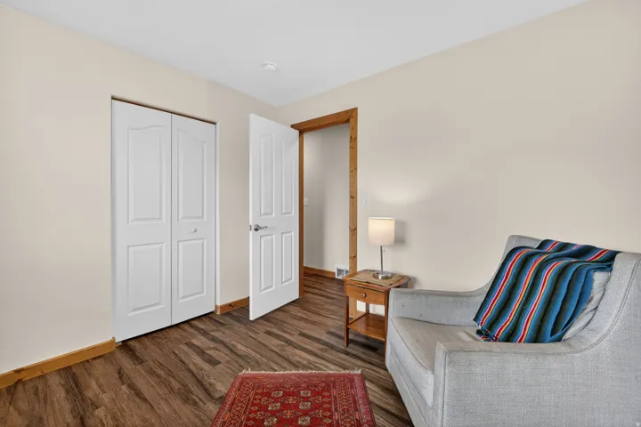 Sitting room featuring dark wood-style floors and baseboards