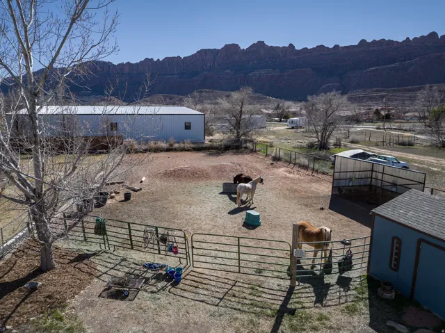 View of yard with an outdoor structure, a view of rural / pastoral area, and a mountain view