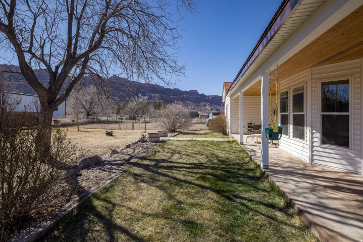 Fenced backyard with a patio area and a mountain view