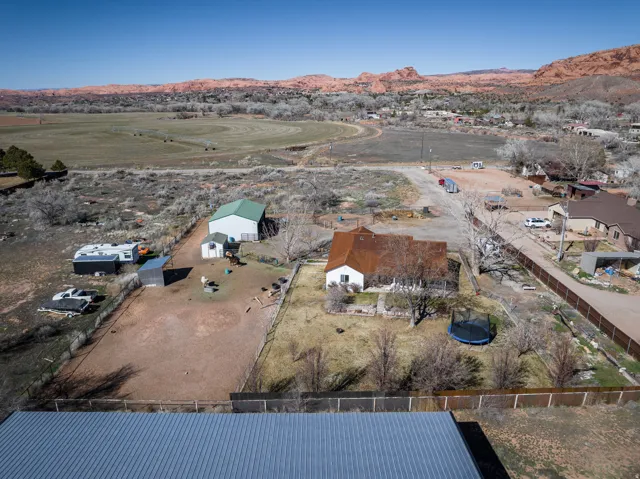 Aerial overview of property's location with a mountainous background and rural landscape
