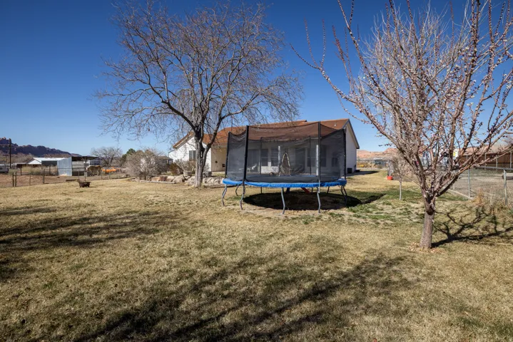 Fenced yard with a trampoline