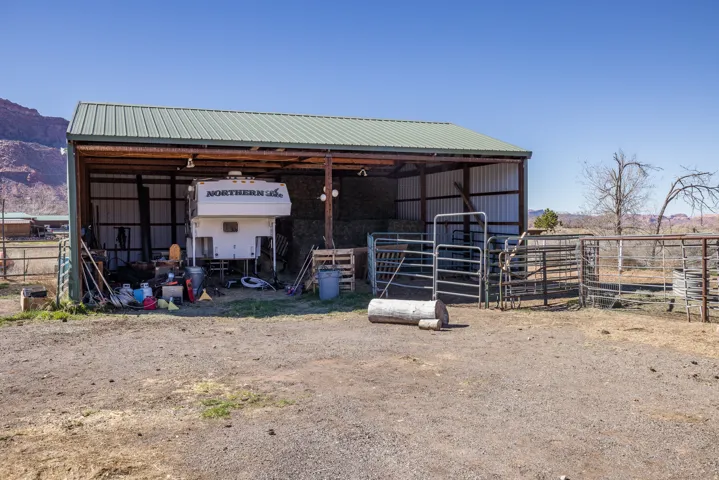 View of outdoor structure with a detached carport, an exterior structure, and a mountain view