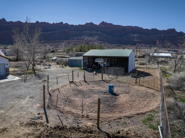 View of yard with an outbuilding, a mountain view, an exterior structure, and a view of countryside