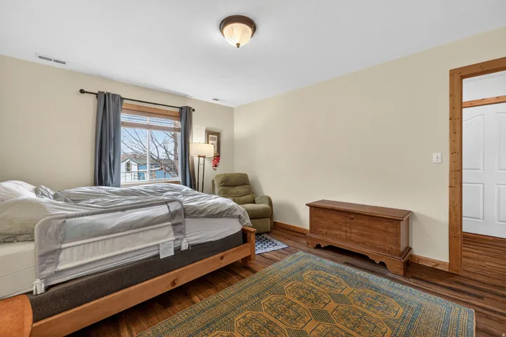 Bedroom featuring wood finished floors and baseboards