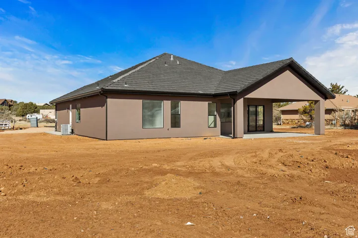 Rear view of property with a patio and stucco siding