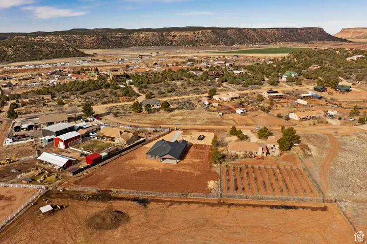 Aerial overview of property's location featuring a mountainous background, nearby suburban area, and rural landscape