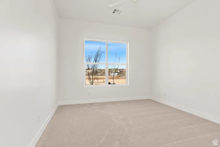 Empty room with light carpet and baseboards