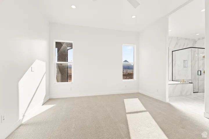 Empty room with light carpet, recessed lighting, and a ceiling fan
