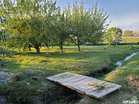 View of grassy yard with a water view