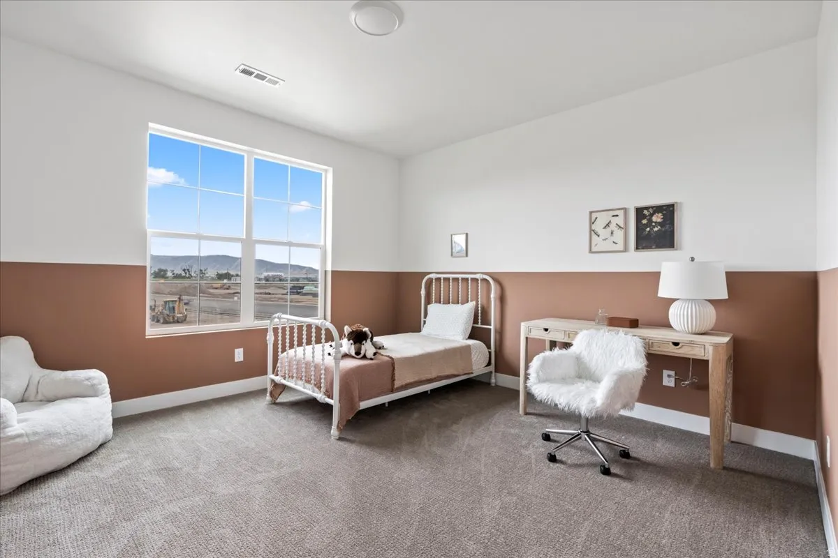 Bedroom with a mountain view and carpet floors with walk in closet