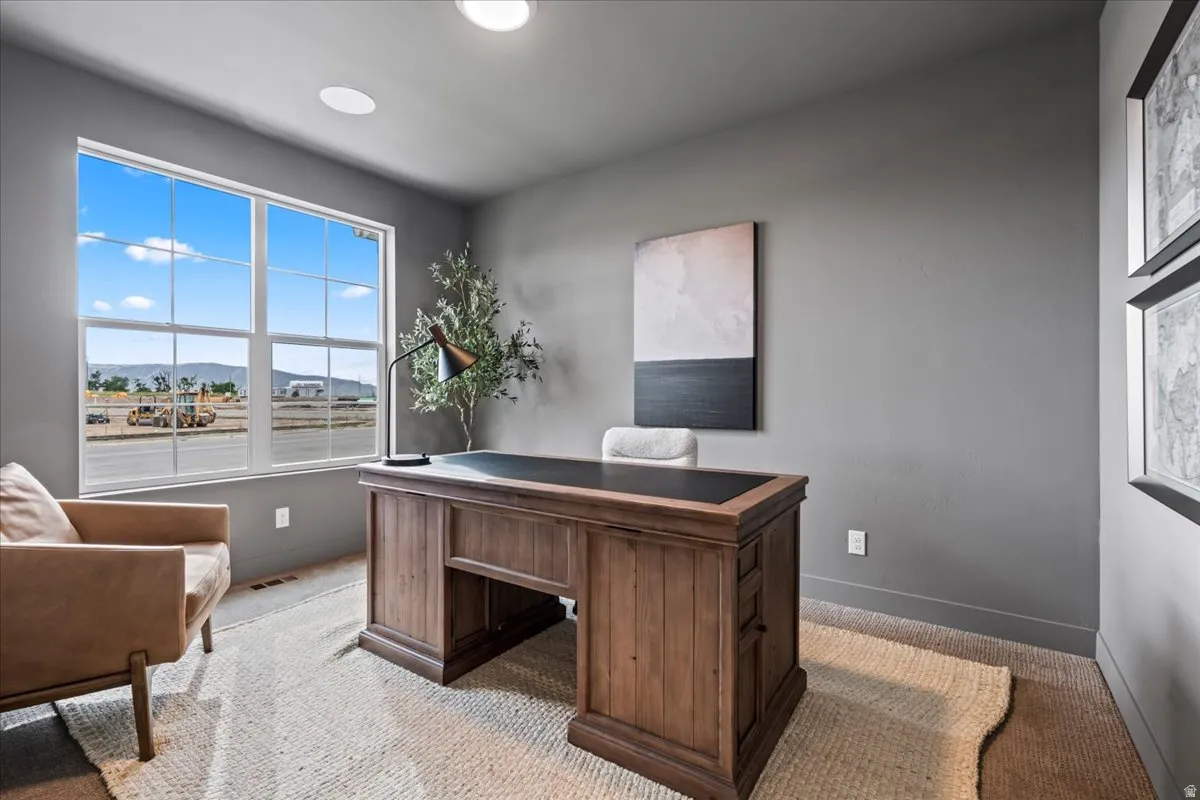 Office area featuring a mountain view and light carpet