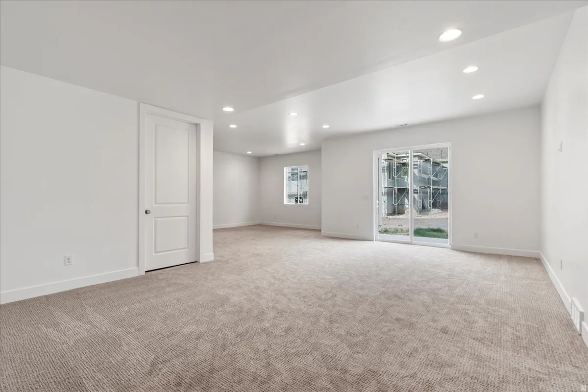 Great room with carpet and daylight, walkout sliding doors