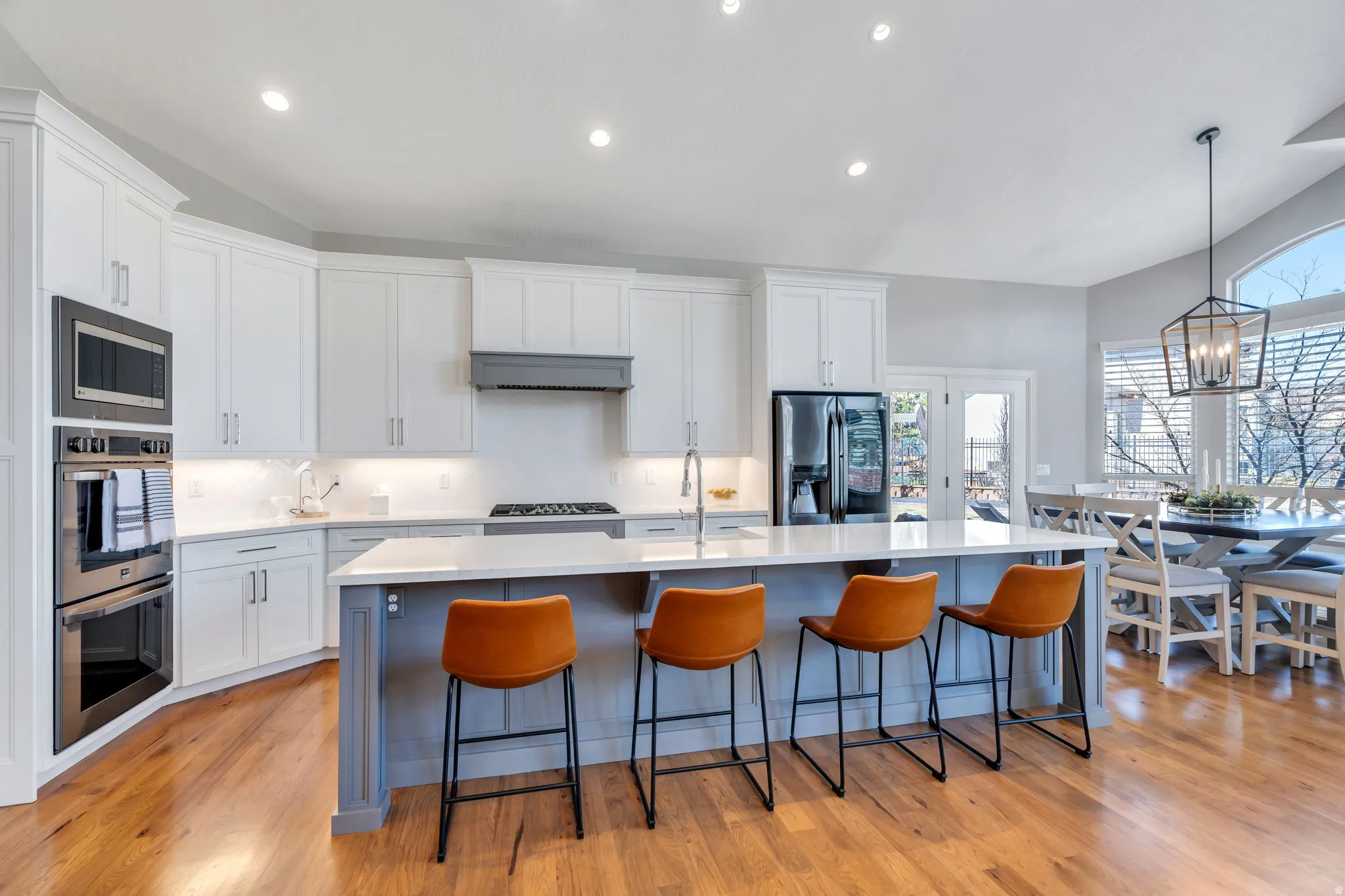 Kitchen with , stainless steel appliances, custom  cabinetry, a kitchen breakfast bar, and an island with sink
