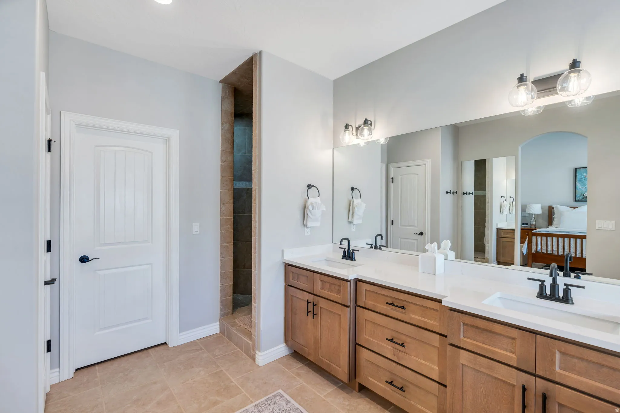 Master bathroom with double vanity, and a walk in shower