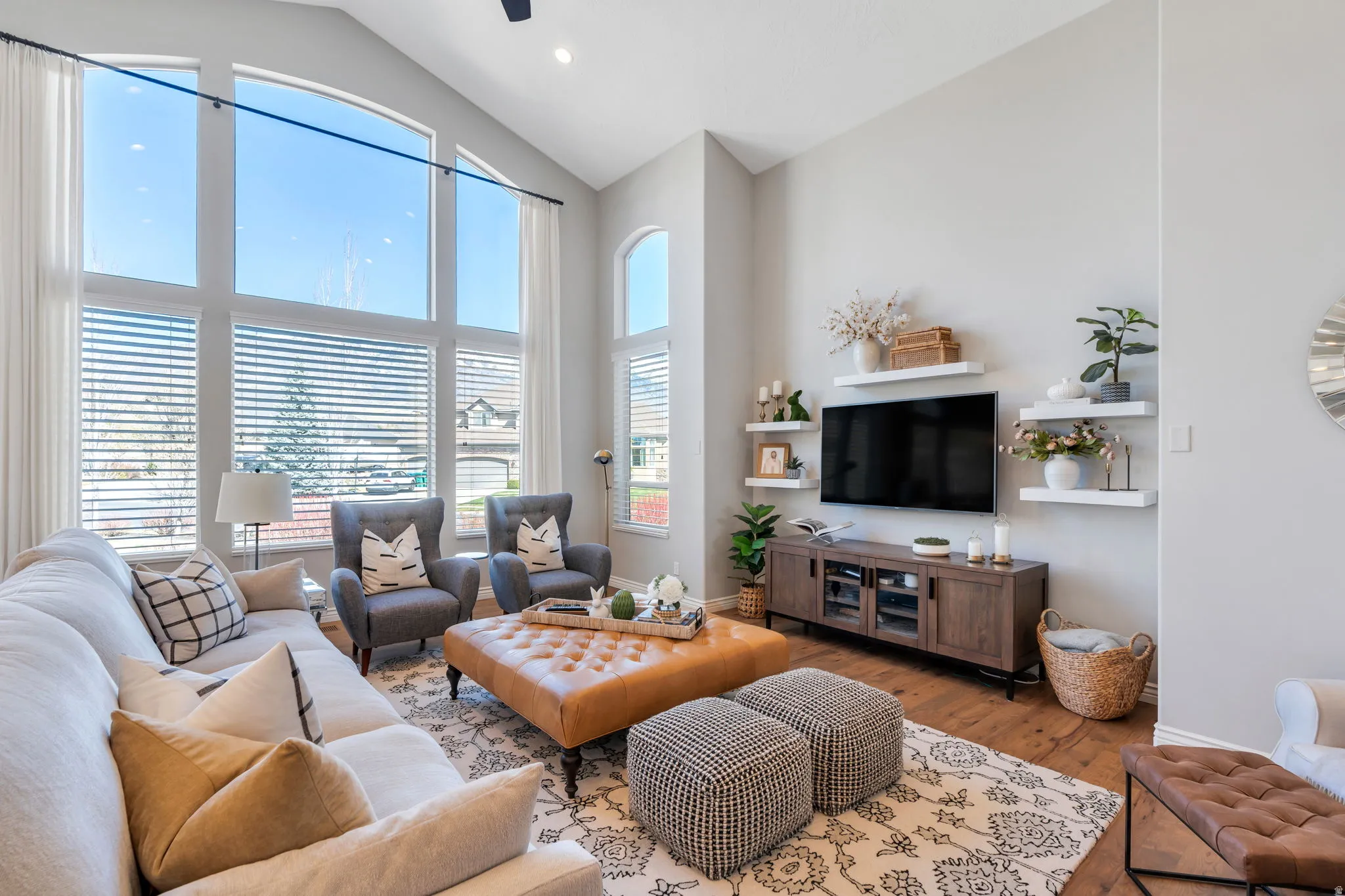 Living area with wood finished floors, vaulted ceiling, and recessed lighting
