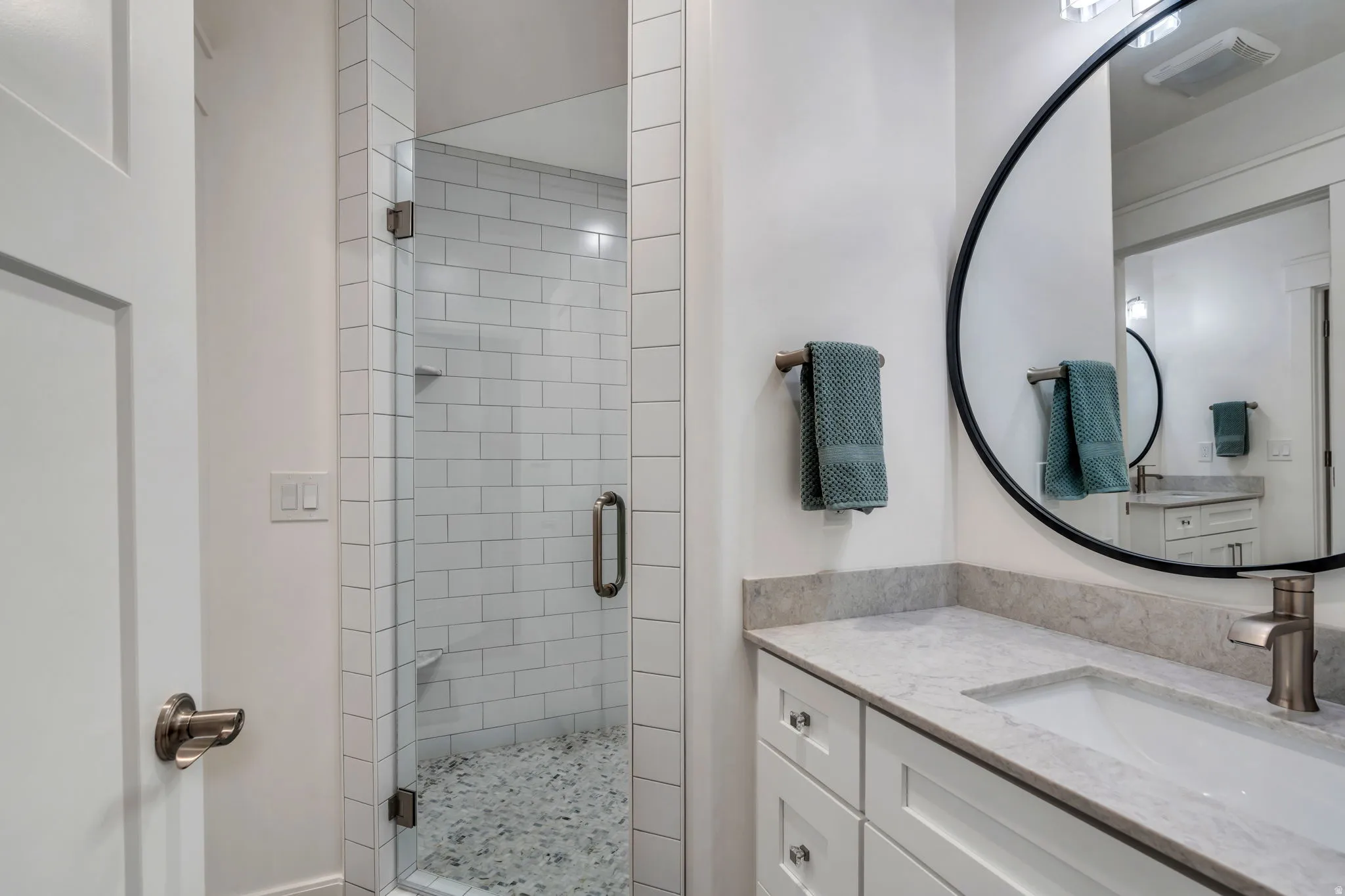 Downstairs Bathroom one of two featuring vanity and a walk-in shower