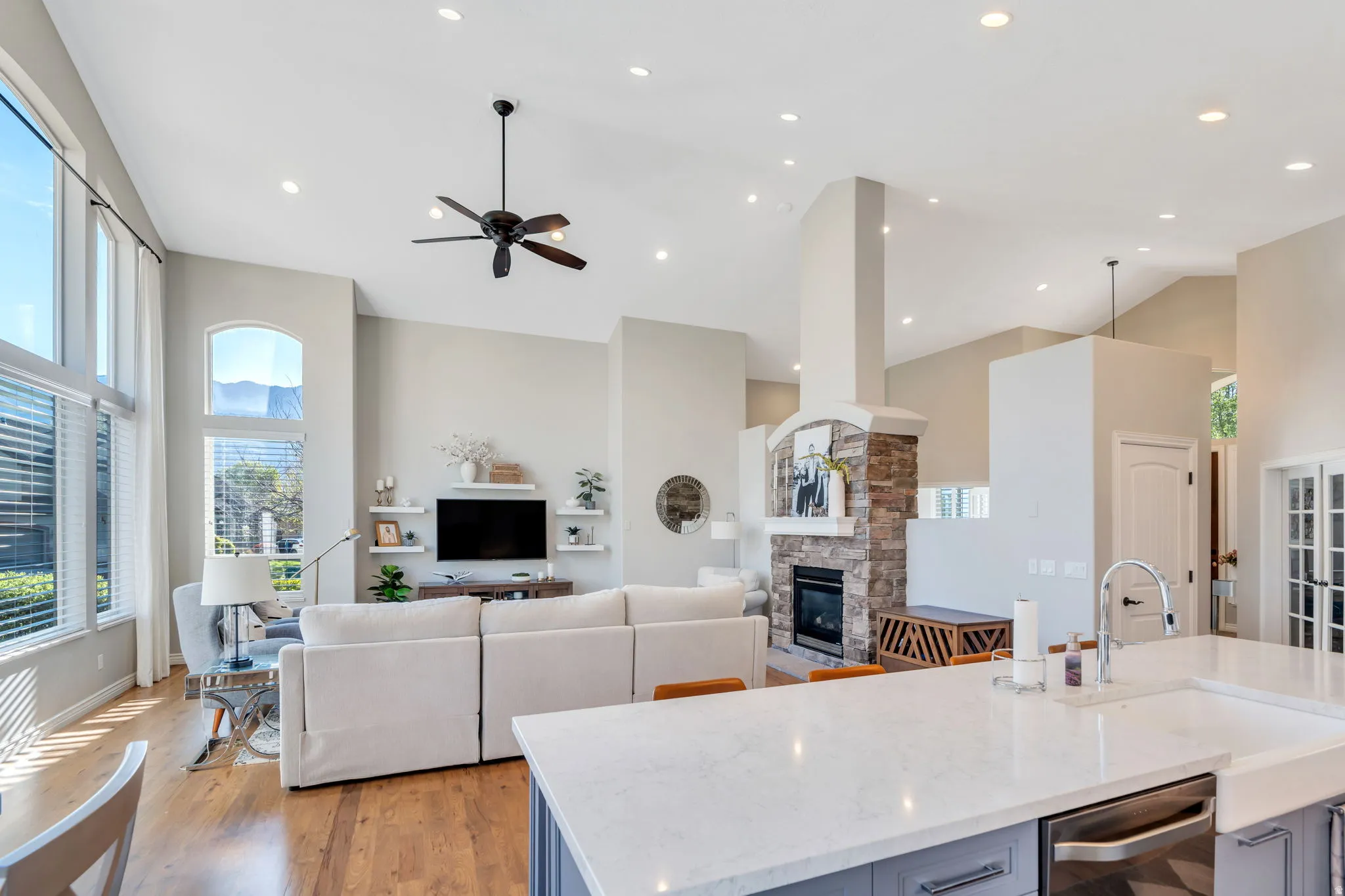 Expansive living area featuring vaulted ceilings, recessed lighting, and wood-finish flooring