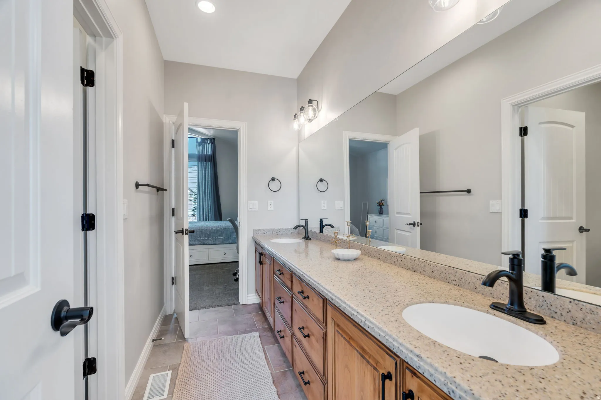 Jack and Jill Bathroom with double vanity, and  tile  floors