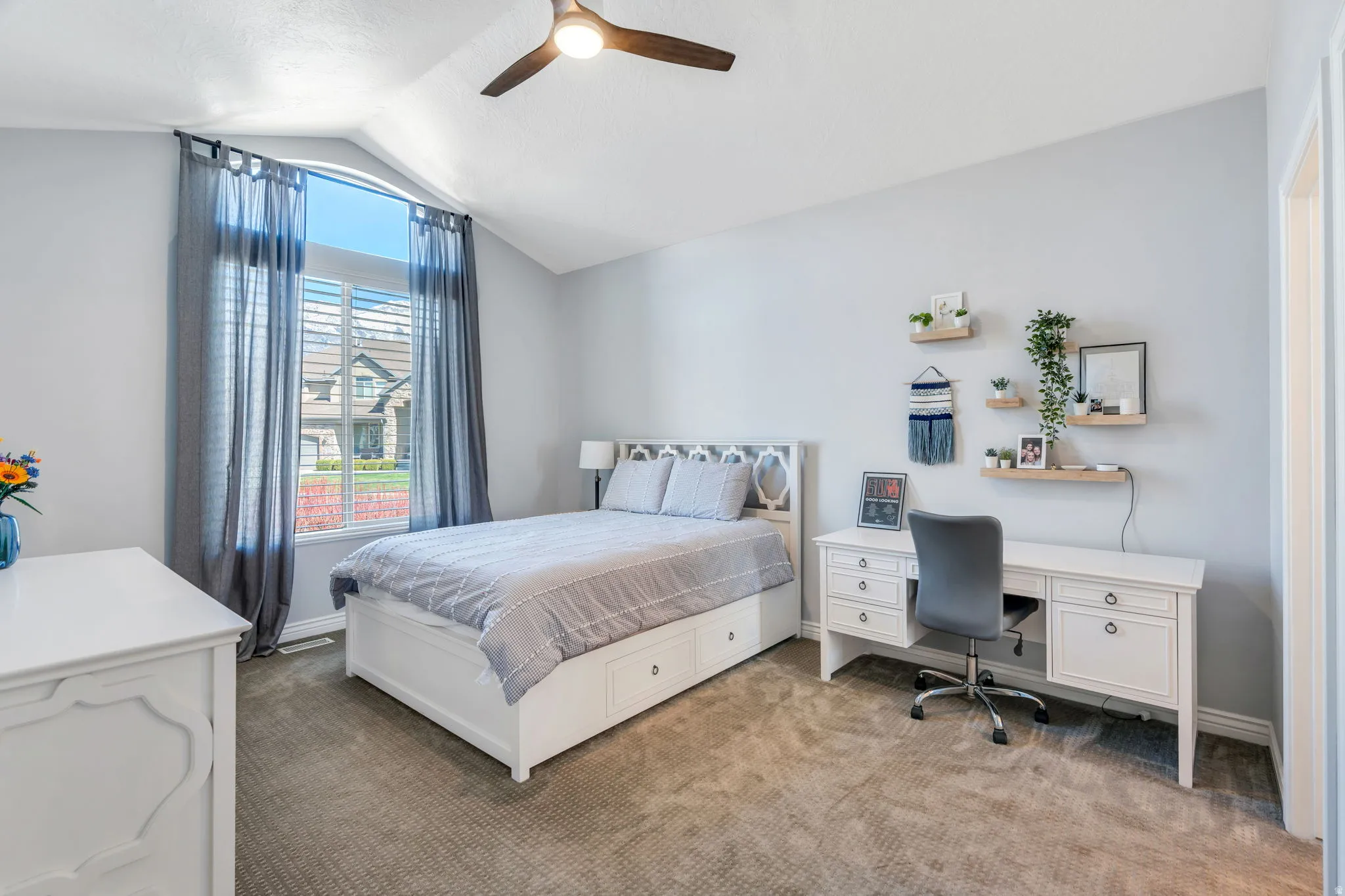 Bedroom featuring  carpet, and a  ceiling fan