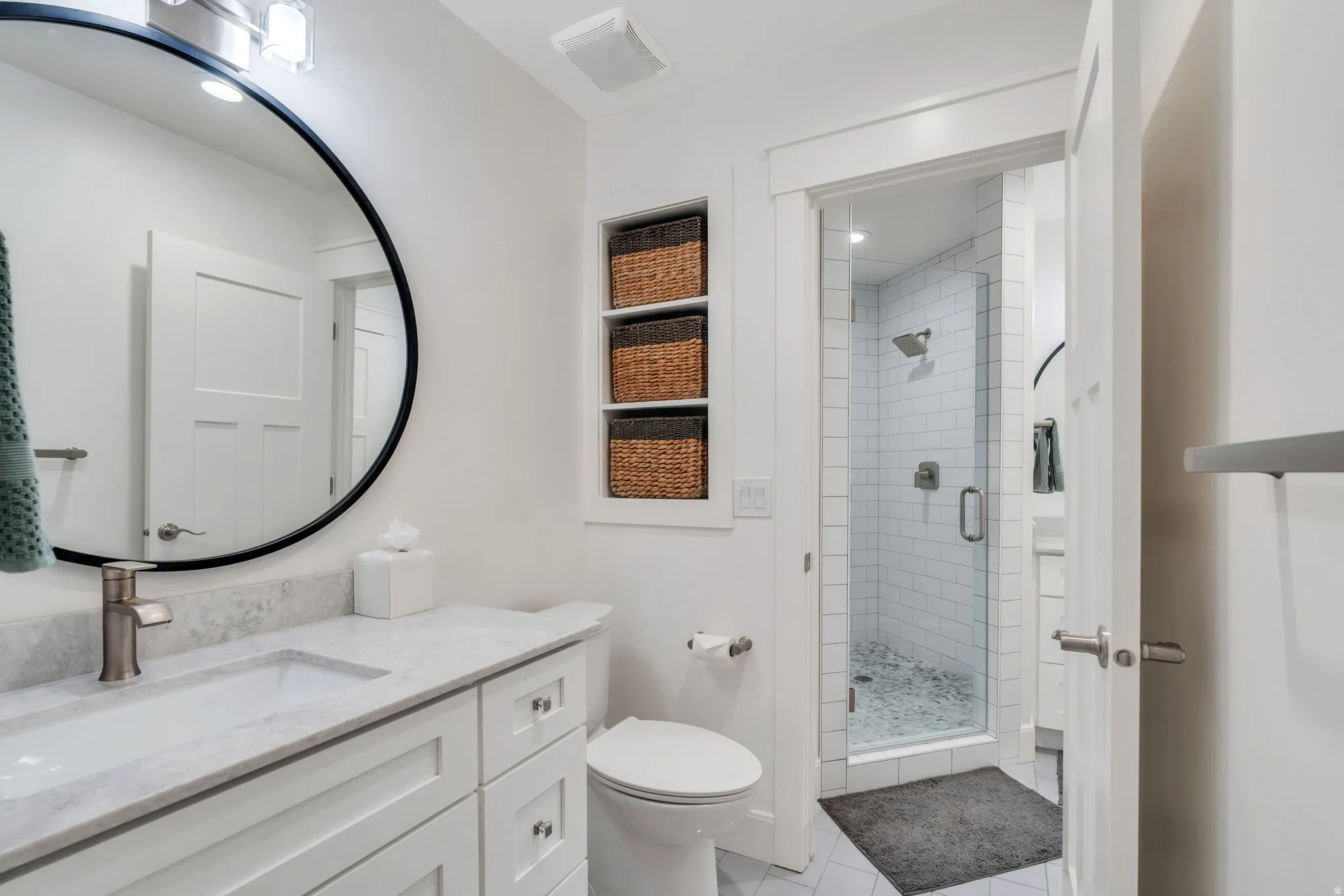Downstairs Full bathroom one of two with a walk-in shower, vanity, and recessed lighting
