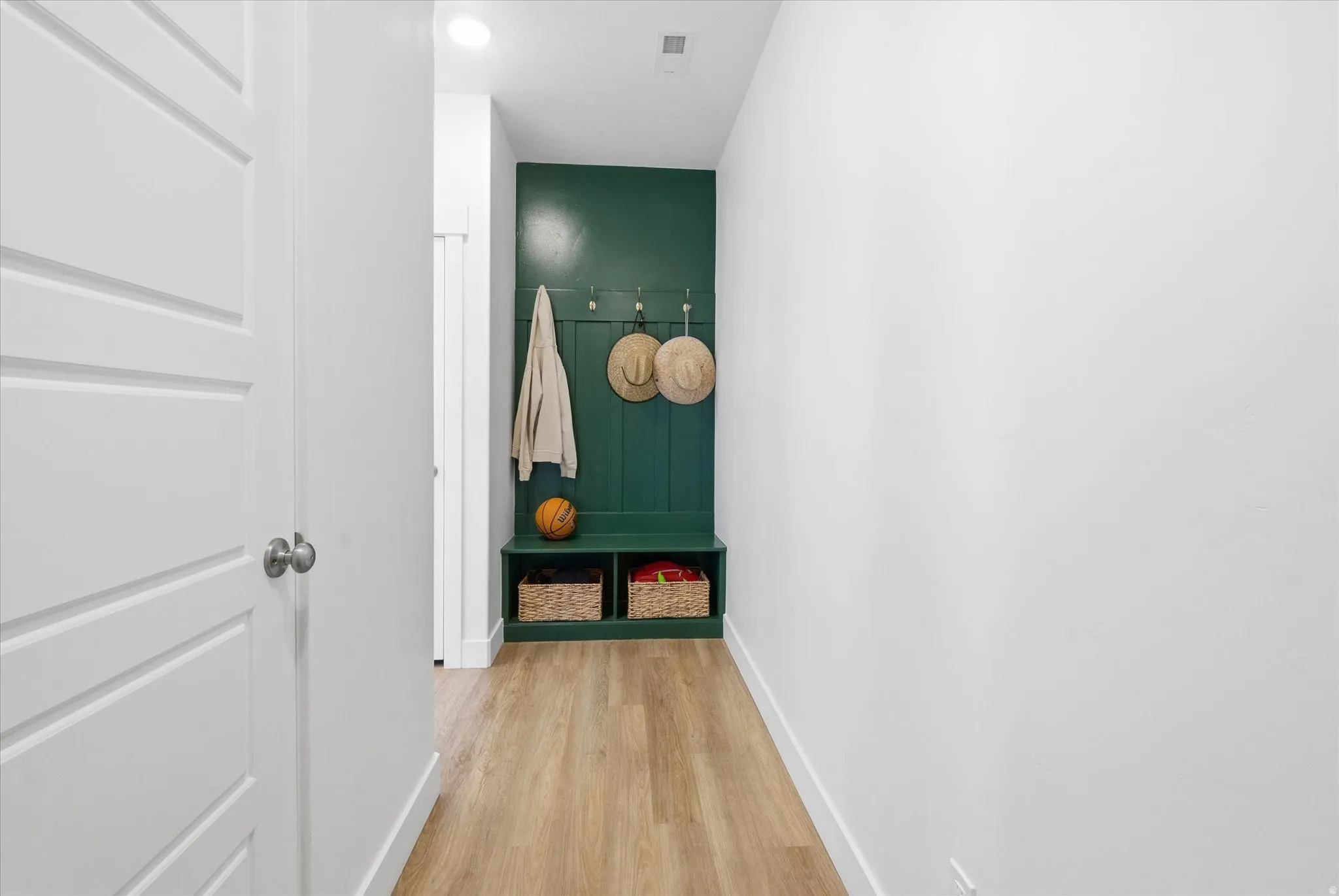 Hall featuring baseboards and light wood finished floors