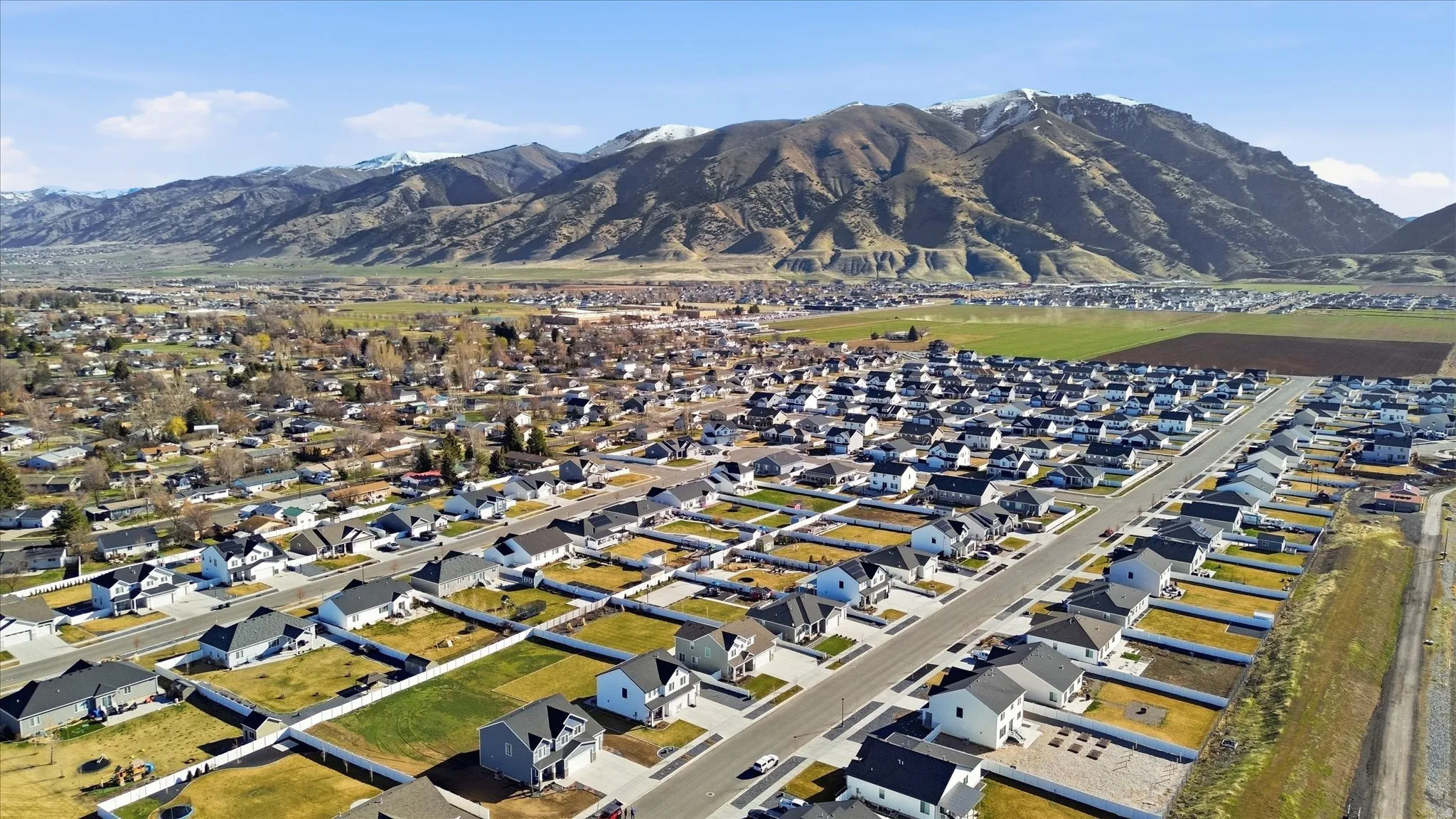 Aerial overview of property's location with nearby suburban area and a mountain backdrop