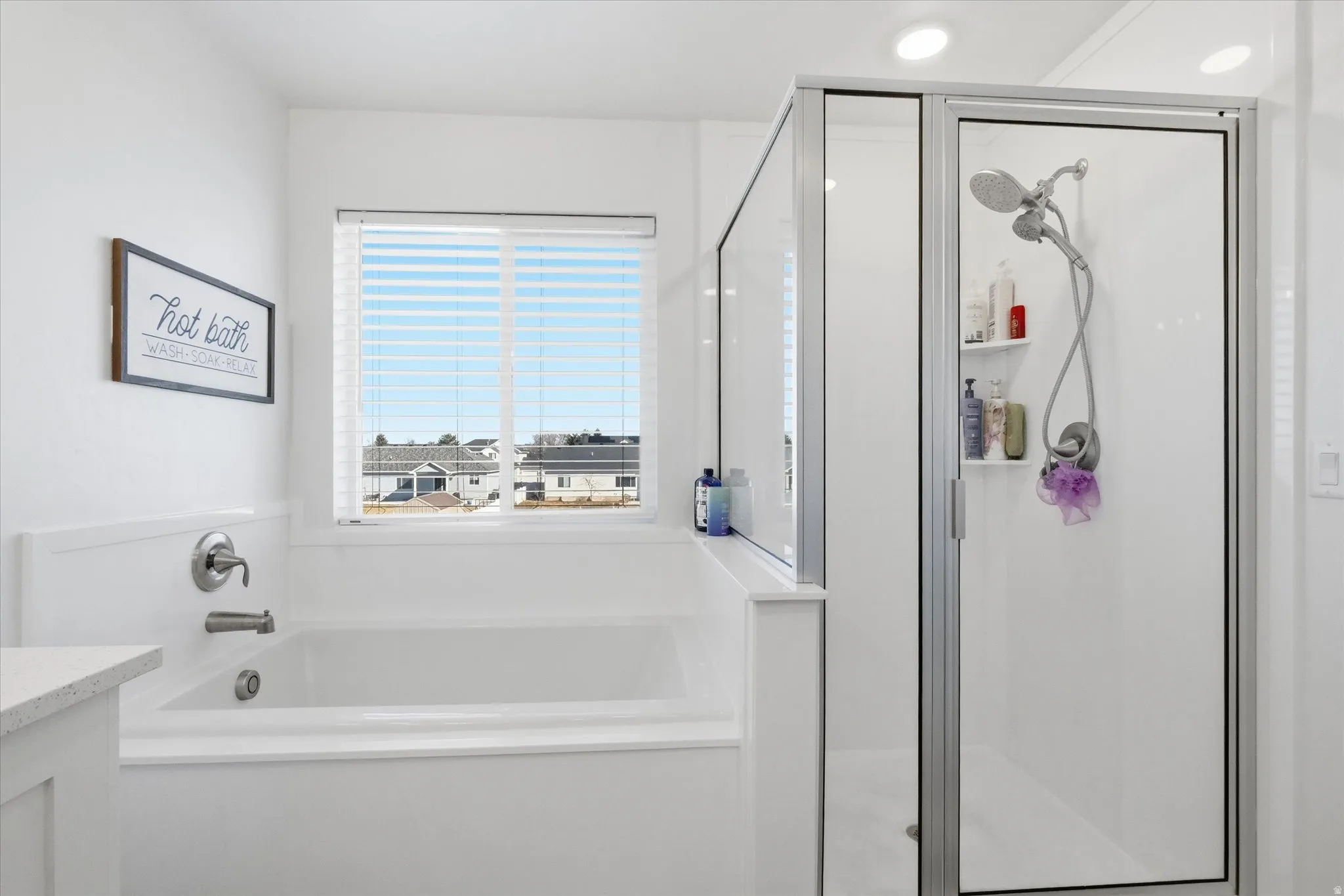 Primary Bathroom featuring vanity, a stall shower, and a garden tub