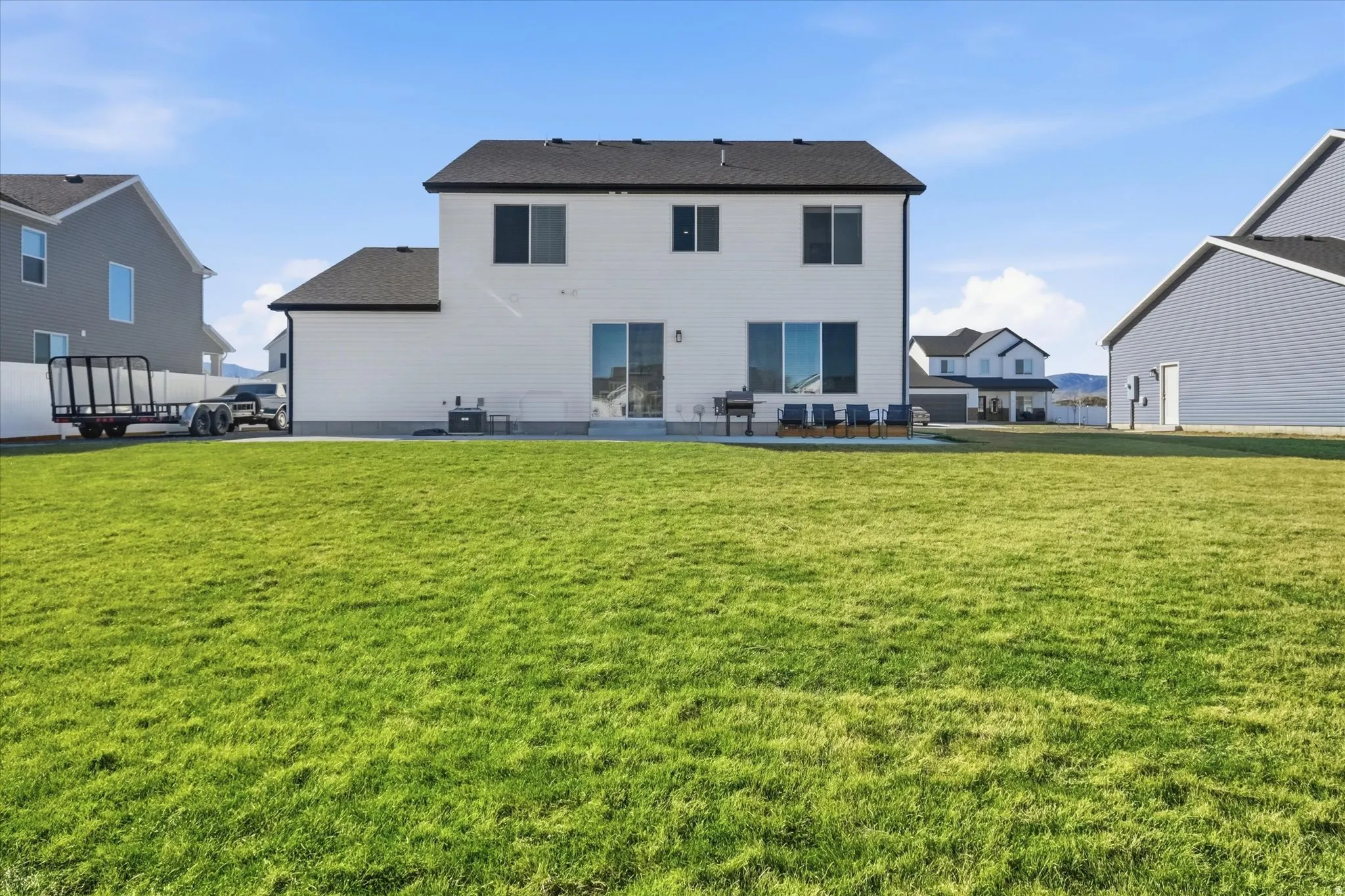 Rear view of property featuring a patio area and a yard