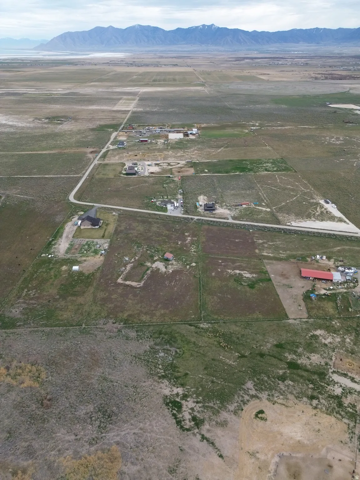 Aerial overview of property's location featuring rural landscape and a mountainous background